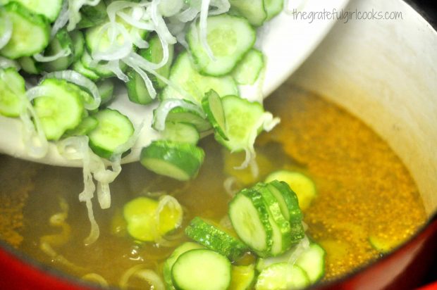 Adding pickling cucumbers and onions to bring in large saucepan