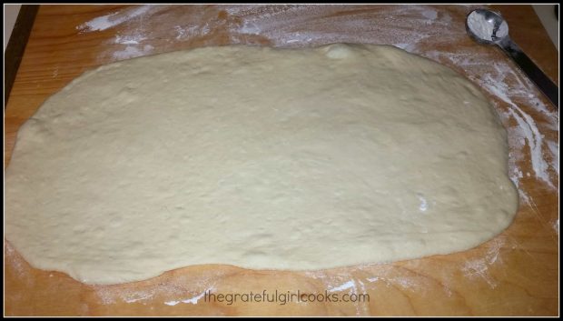 The dough is rolled out into a large rectangle.