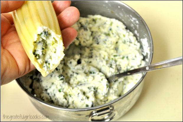 Stuffing the florentine manicotti shells before baking.