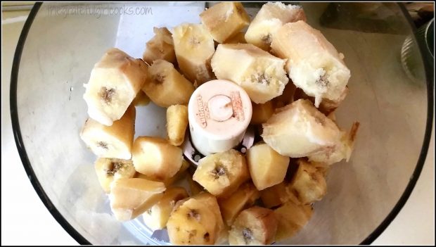 Frozen chunks of banana are placed in a food processor.
