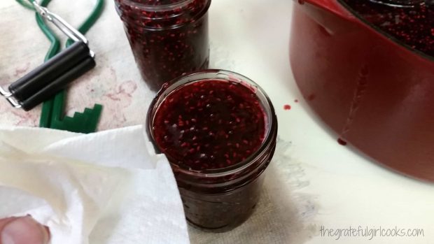 Rims of the jam jars are wiped clean so lids will seal.