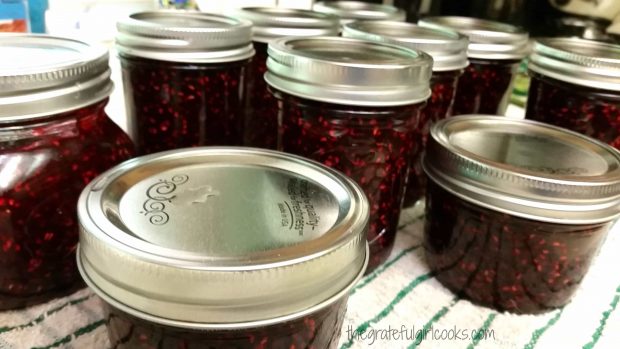 Raspberry jam in sealed jars cool to room temperature after processing.