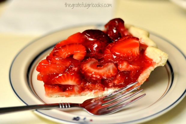 One slice of strawberry pie on a plate with a fork.