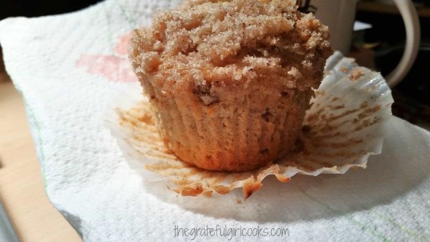 Baked apple crumb muffin on a paper towel