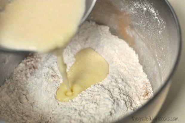 Pouring muffin batter into dry ingredients in bowl