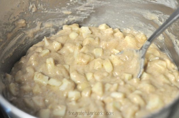 Muffin batter with apple chunks in bowl
