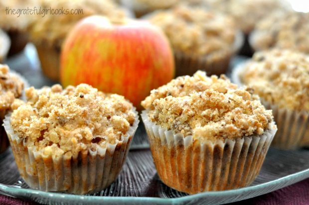 Two muffins close up with apple on plate