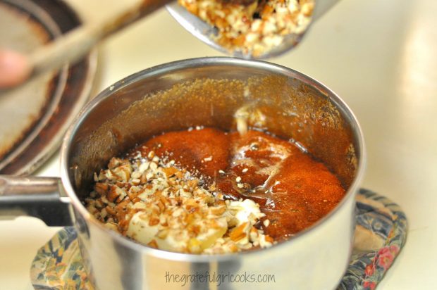 Adding chopped pecans for bacon pecan pralines to saucepan