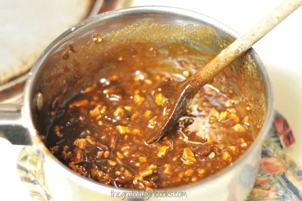 Hot bacon pecan pralines mixture, in saucepan after cooking.