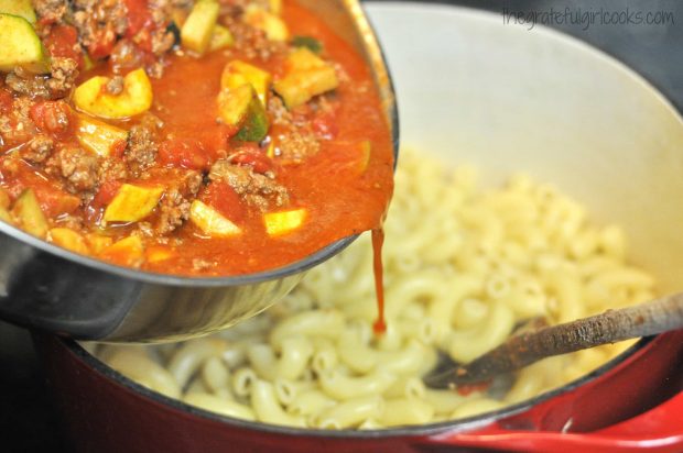 Summer squash, chili beef and tomatoes are poured over cooked macaroni