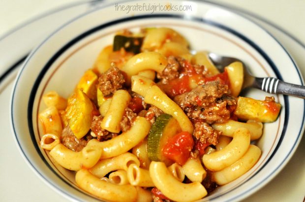 Chili mac with summer squash is placed into bowls for serving