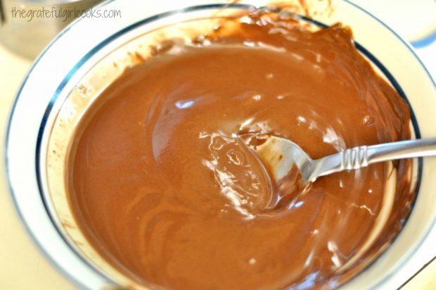 Heating chocolate for dipping peanut butter filled graham crackers.