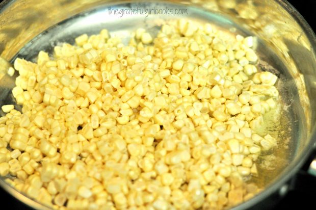 Fresh corn kernels are cooked in large skillet with butter