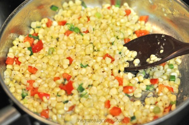 Corn, peppers and green onions are sauteed for a couple minutes.