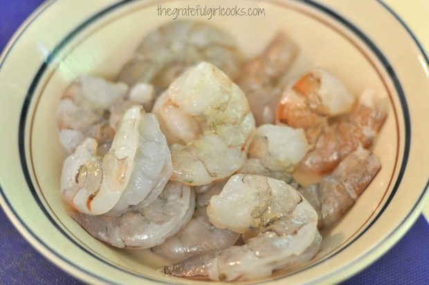 Shrimp are cleaned, shelled and de-veined before making kabobs.