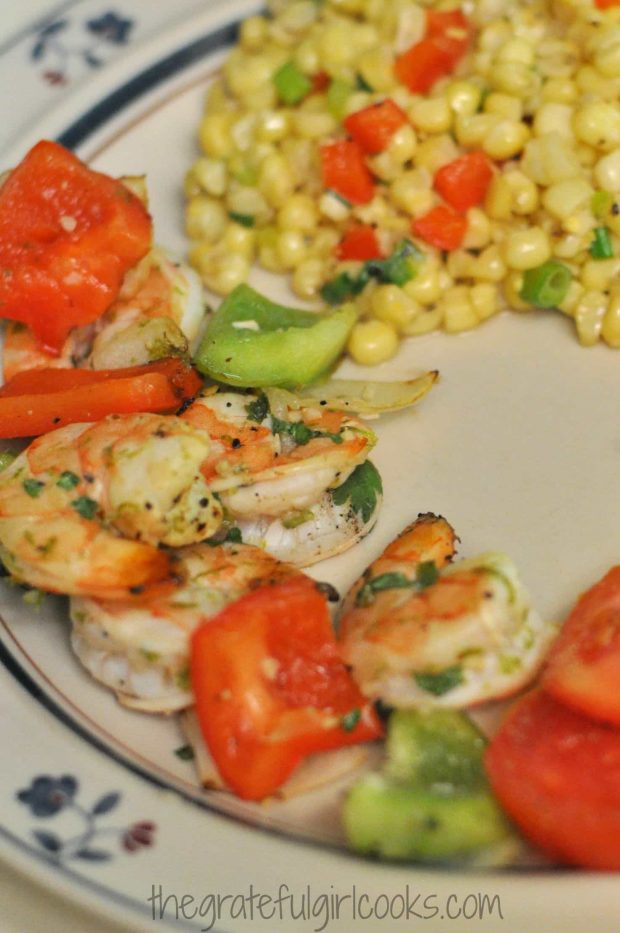 The shrimp is removed from the skewers and served with some corn on the side.