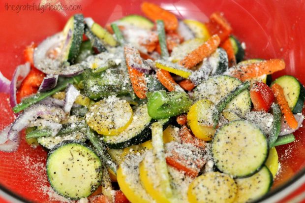 Summe veggies are seasoned with olive oil, Parmesan cheese and Italian spices before grilling.