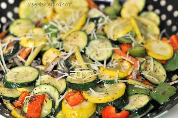 Grilled Summer Veggies are sprinkled with grated Parmesan cheese before serving.