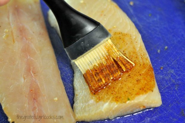 Sauce brushed onto mahi mahi fillets, on blue mat