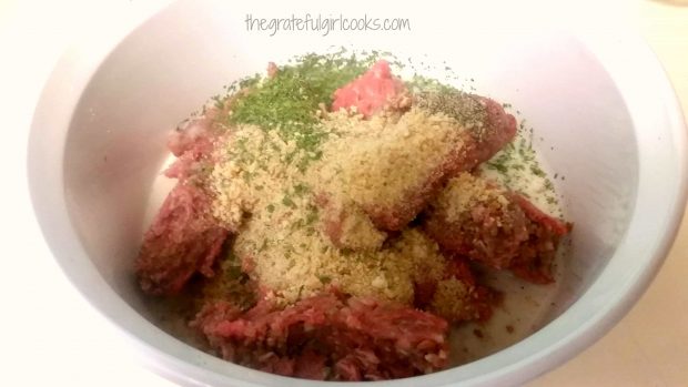 Ground beef, bread crumbs and spices in mixing bowl to make meatballs for meatballs stroganoff.