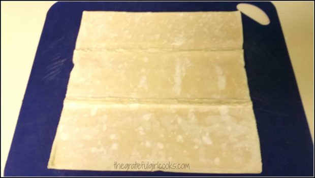 Puff pastry is rolled out and perforated lines in dough are sealed.