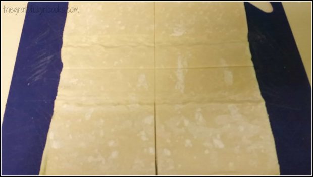 Peach turnover dough is cut into 4 equal squares.