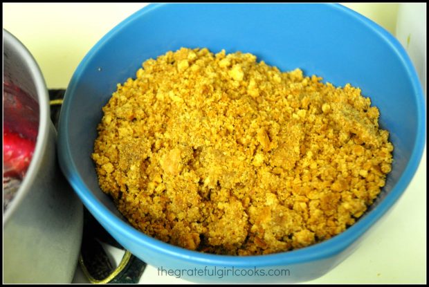 Ingredients for the graham cracker crust are mixed together in bowl.