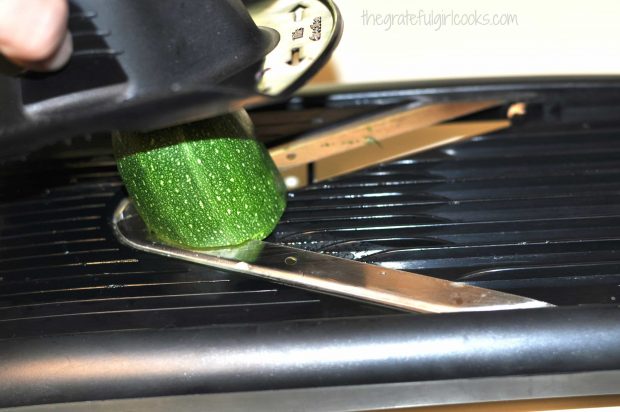 Slicing zucchini for salad very thinly using a mandolin