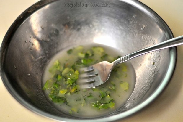 Salad dressing for carpaccio salad mixed in small metal bowl