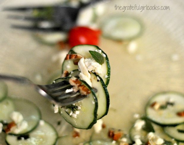 Close up bite of zucchini and cucumber salad on fork