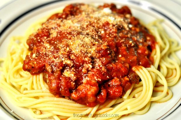 Easy Spaghetti Sauce With Italian Sausage is served on top of pasta!