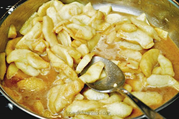 Apple slices cooking with brown sugar, cinnamon, etc. for mini apple crisps.