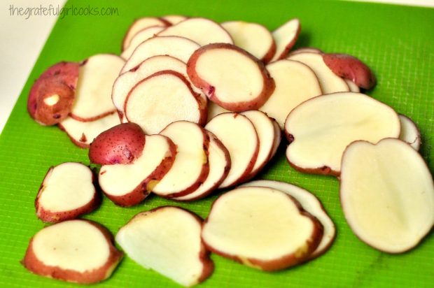 The red potatoes are sliced into rounds before cooking.