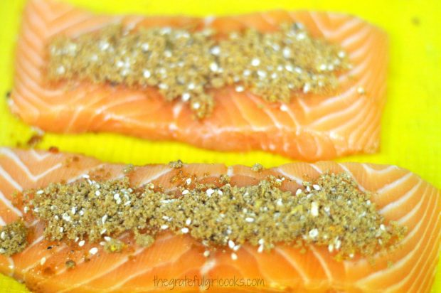 Salmon fillets are coated with a brown sugar spice rub before cooking.