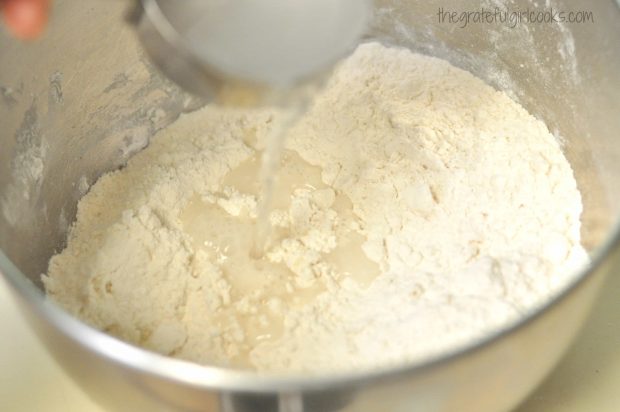 Hot water is added to dumplings dough, then mixed together.