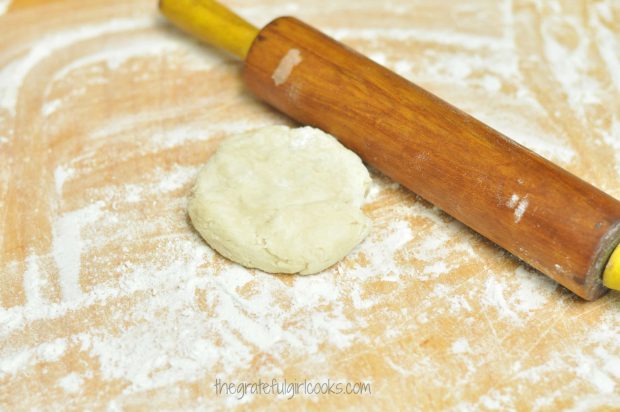 Each dumpling dough ball is rolled out on a floured surface