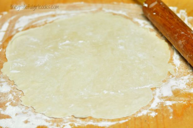 Dumpling dough is rolled out until very thin on floured suface