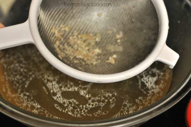 Straining chicken broth for soup