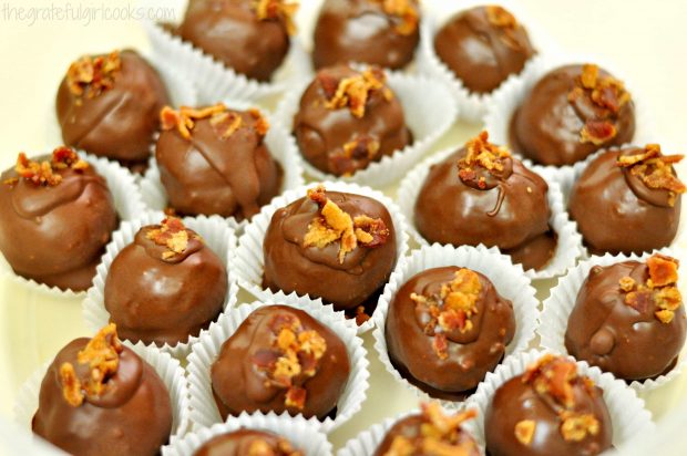 To serve, the maple bacon pecan truffles are placed into paper candy wrappers.