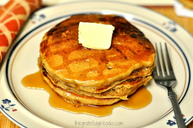 Pumpkin chocolate chip pancakes served with butter and maple syrup.