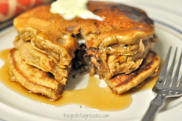 Pumpkin chocolate chip pancakes on plate with fork.