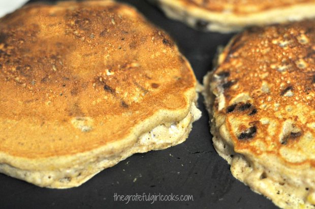 Pumpkin chocolate chip pancakes are flipped when they get brown.