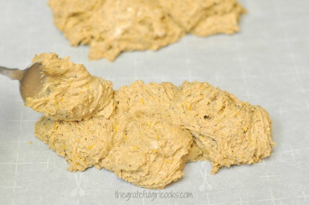 Two log shapes are formed by spreading out the pumpkin spice latte biscotti batter on parchment paper.