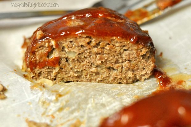 A slice of meatloaf has been cut, and is ready to serve.