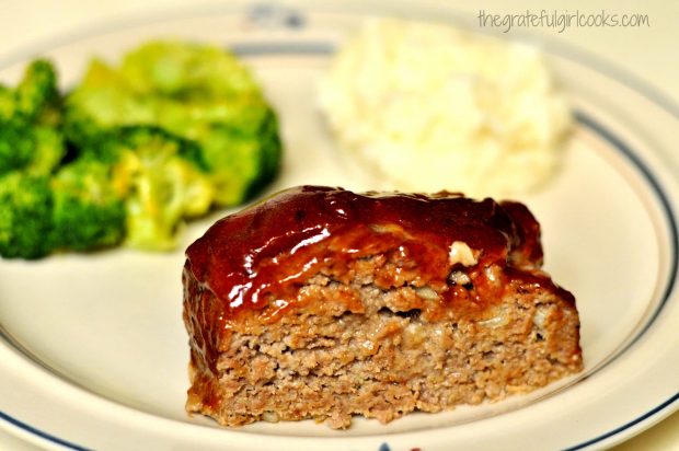 Meatloaf slice on a plate, with mashed potatoes and broccoli on the side.