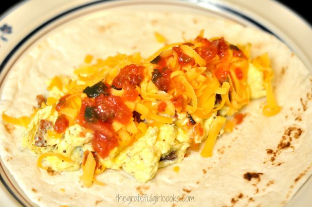 Breakfast Burritos are filled with eggs, bacon, cheddar cheese and salsa before rolling.