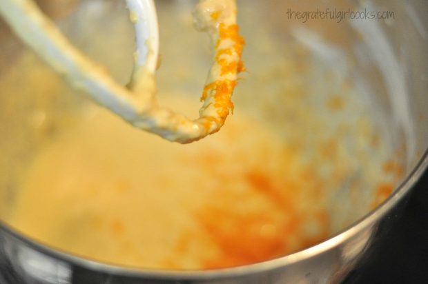 Zest from an orange is added to cranberry muffin batter.