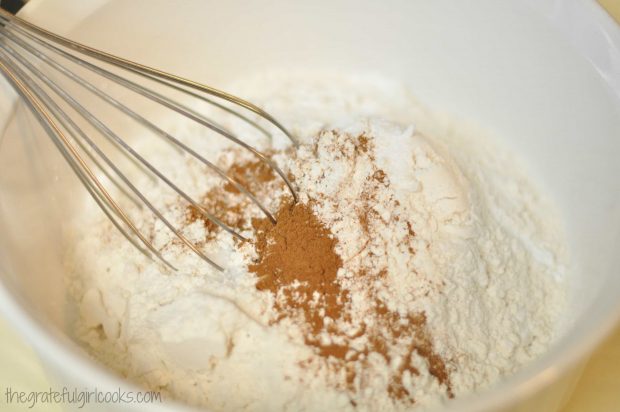 Dry ingredients are whisked together for cranberry orange muffins.