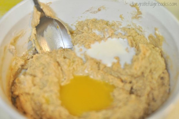 Milk and orange juice is added to muffin batter.