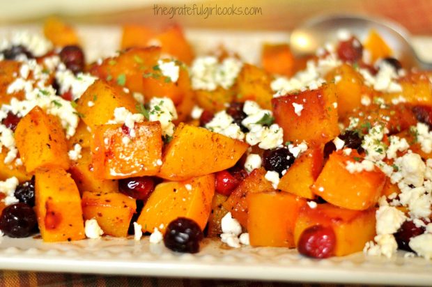 Roasted Butternut Squash with Cranberries, Feta & Honey on white platter, ready to eat!